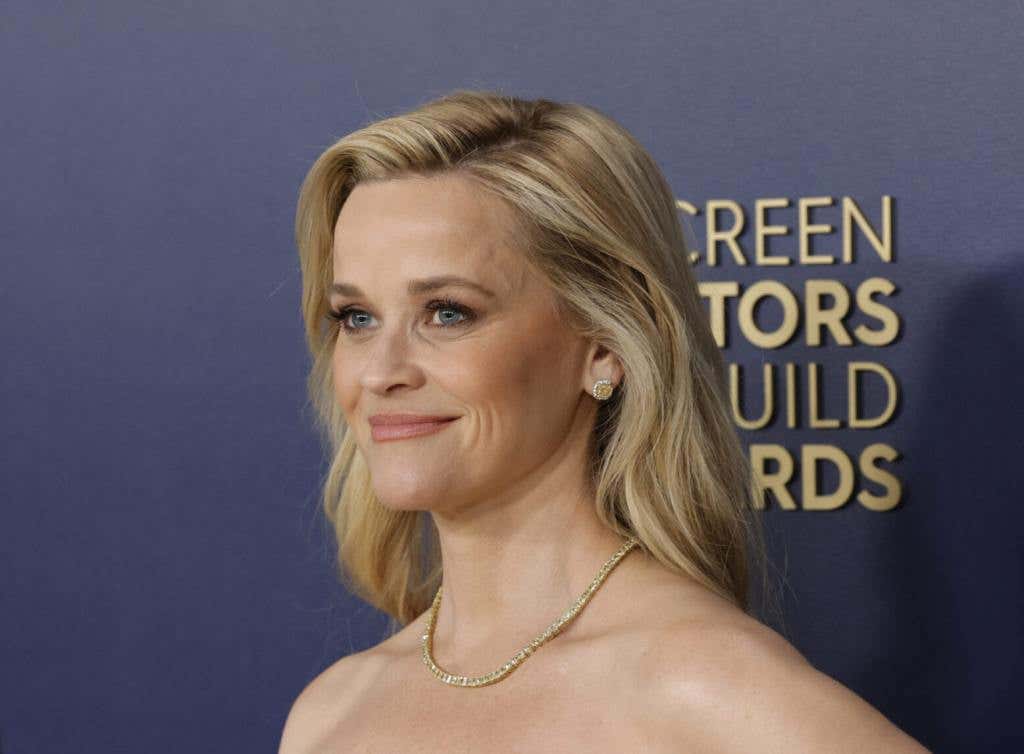 Reese Witherspoon attends the 30th Annual Screen Actors Guild Awards smiling facing right, Reese Witherspoon's 6 Most Iconic Roles Of All Time.