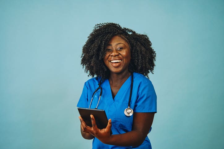 Nurse practitioner doctor with tablet and stethoscope smiling