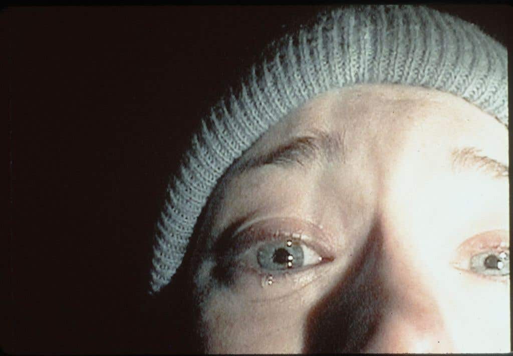 iconic closeup of Heather Donahue's face from the 1999 film "The Blair Witch Project."