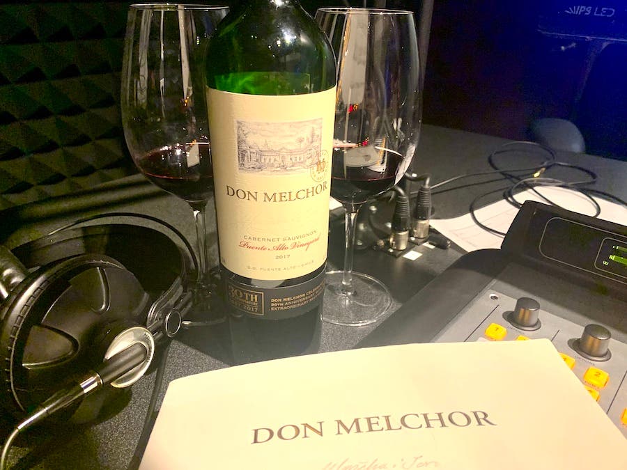 Don Melchor wine bottle wtih two glasses and a set of headphones