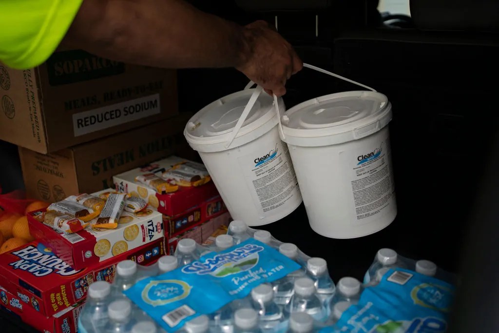 Volunteers and staff of Harris County Precinct One give out donated items, including water, sanitary wipes, and emergency meals, at its Central Service Center on July 11, 2024 in Houston, Texas. Nearly one million people still remain without electricity in the wake of Hurricane Beryl, which was a category one hurricane that made a direct hit on Houston and surrounding areas on July 8, leaving more than two million people without power.