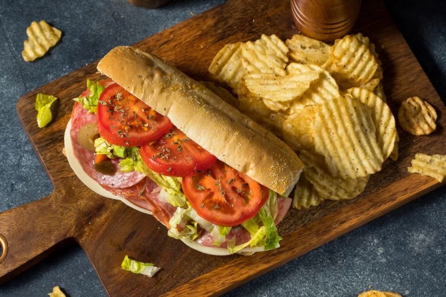 Sub sandwich stacked with toppings and thin slices of fresh tomatoes for Southwest Florida kids eat free