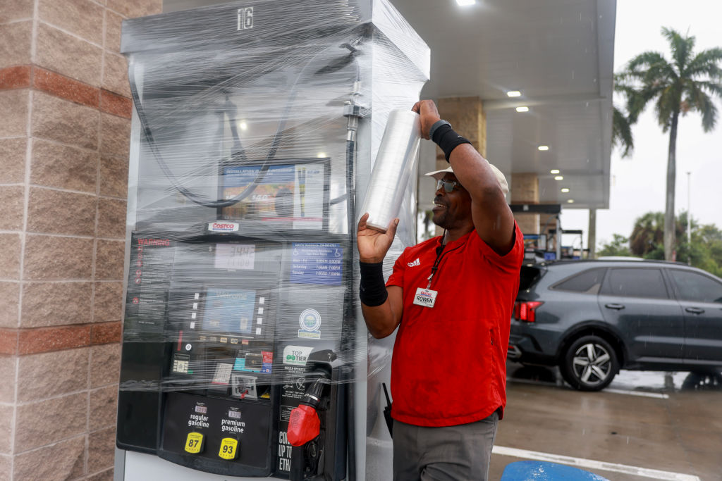 Rown Williamson secures a gas pump at a Costco store before the arrival of Hurricane Milton on October 08, 2024 in Naples, Florida. People are preparing for the store, which could be a Cat 3, when it makes landfall on Wednesday evening. 